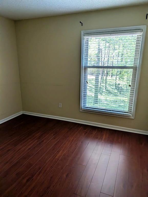 3650 Ashford Dunwoody Road Northeast, Unit 918 Atlanta, GA 30319 - Photo 8 of 17 an empty room with wooden floor and windows