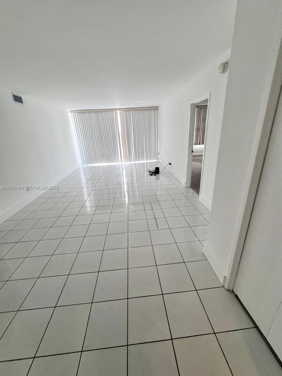 5161 Collins Avenue, Unit 1108 Miami Beach, FL 33140 - Photo 2 of 5 a view of an empty room with a window