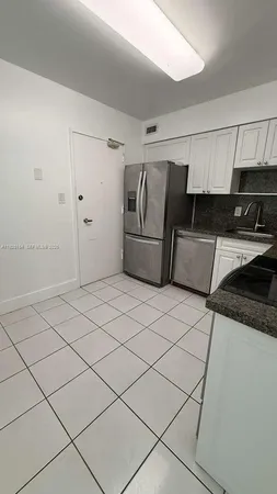 a utility room with cabinets washer and dryer