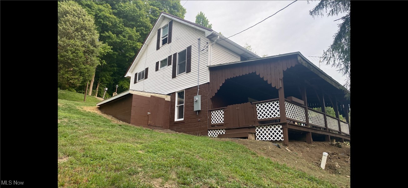 360 Bradys Ridge Road Wellsburg, WV 26070 - Photo 5 of 36 View of home's exterior featuring a yard and a wooden deck