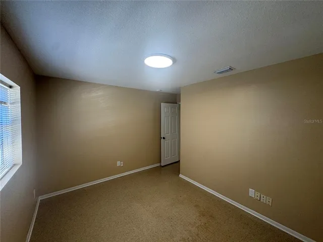 an empty room with a empty space and window