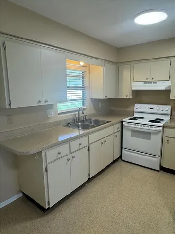 a kitchen that has a sink and a stove in it