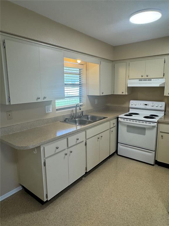 5222 Bogdonoff Drive, Unit A Seffner, FL 33584 - Photo 5 of 16 a kitchen that has a sink and a stove in it