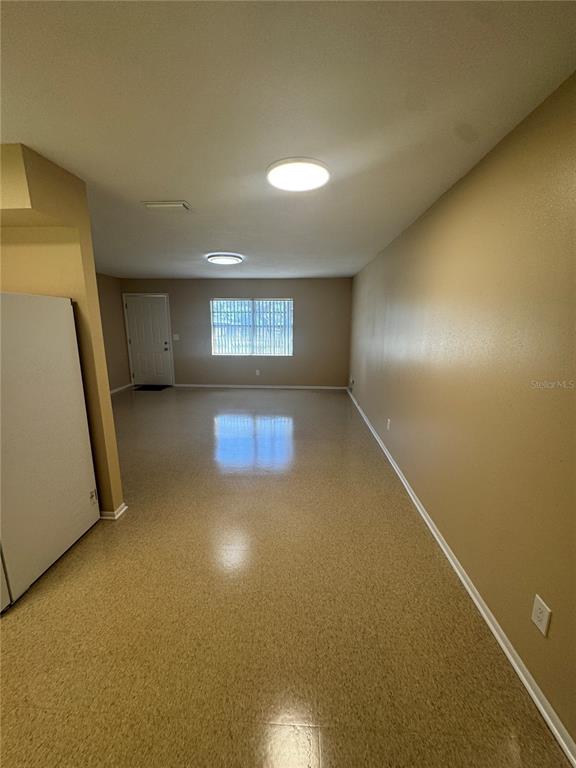 5222 Bogdonoff Drive, Unit A Seffner, FL 33584 - Photo 7 of 16 an empty room with a empty space and windows