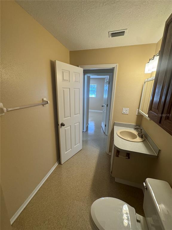 5222 Bogdonoff Drive, Unit A Seffner, FL 33584 - Photo 10 of 16 a bathroom with a sink mirror vanity and toilet