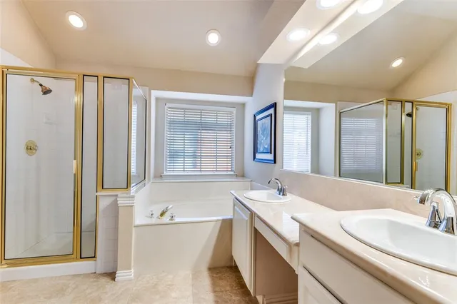 a bathroom with a granite countertop tub sink and mirror