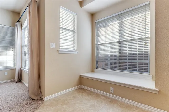 a bathroom with a bathtub and next to a window