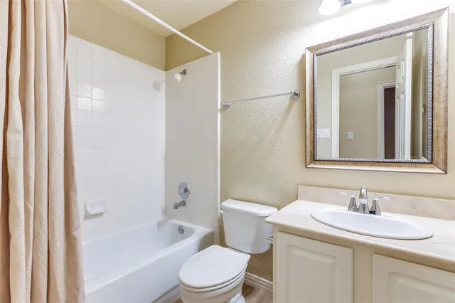 a bathroom with a sink toilet vanity and shower