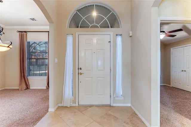 a view of a hallway with wooden floor and a living room