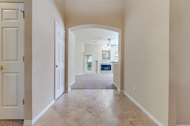 a view of an empty room with floor to ceiling window