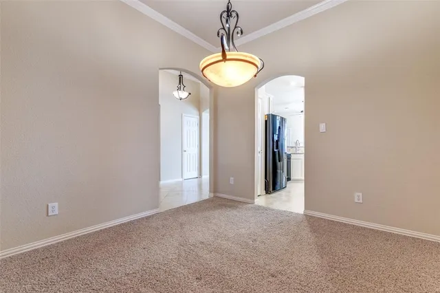 a view of an empty room with window and fireplace