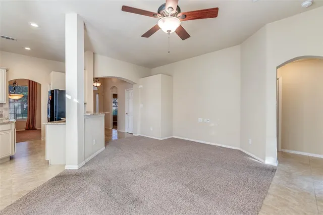 a view of a livingroom with a ceiling fan and window