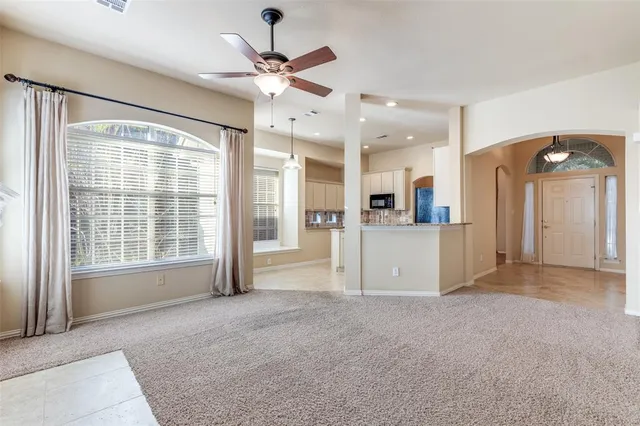 a kitchen with kitchen island granite countertop a sink appliances cabinets and furniture