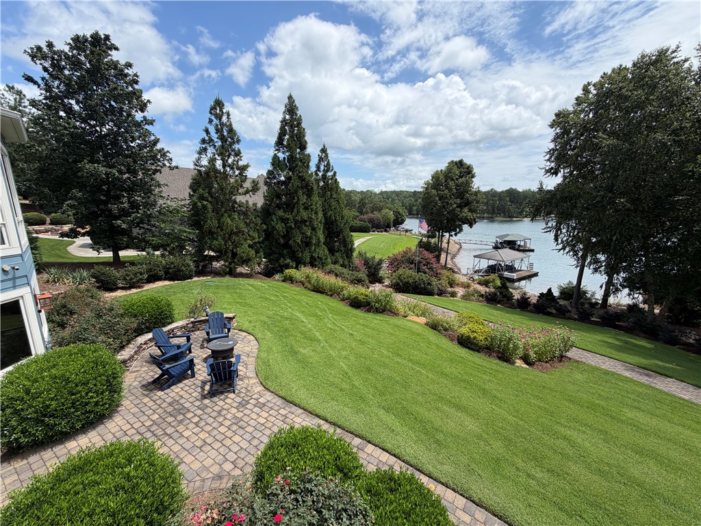 357 Stardust Lane Seneca, SC 29672 - Photo 20 of 50 Manicured lawns slope gently toward the water's edge, highlighting the expansive lakefront setting.