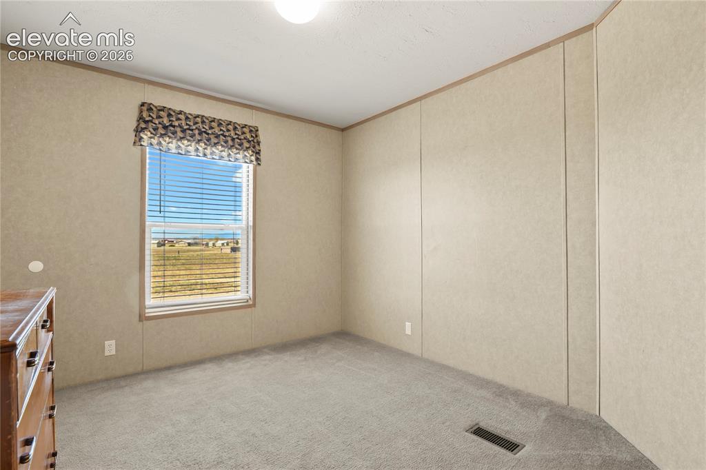 22280 Jones Road Peyton, CO 80831 - Photo 19 of 47 a view of an empty room with a window