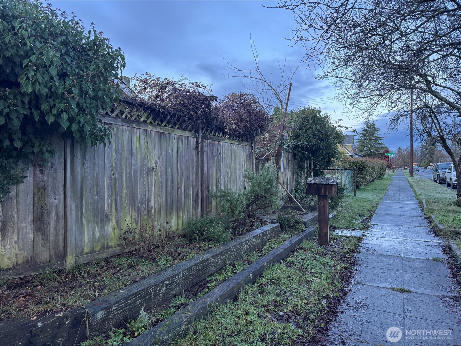 126 West 5th Street Port Angeles, WA 98362 - Photo 3 of 34 a view of a pathway of a park with plants and a bench with wooden fence
