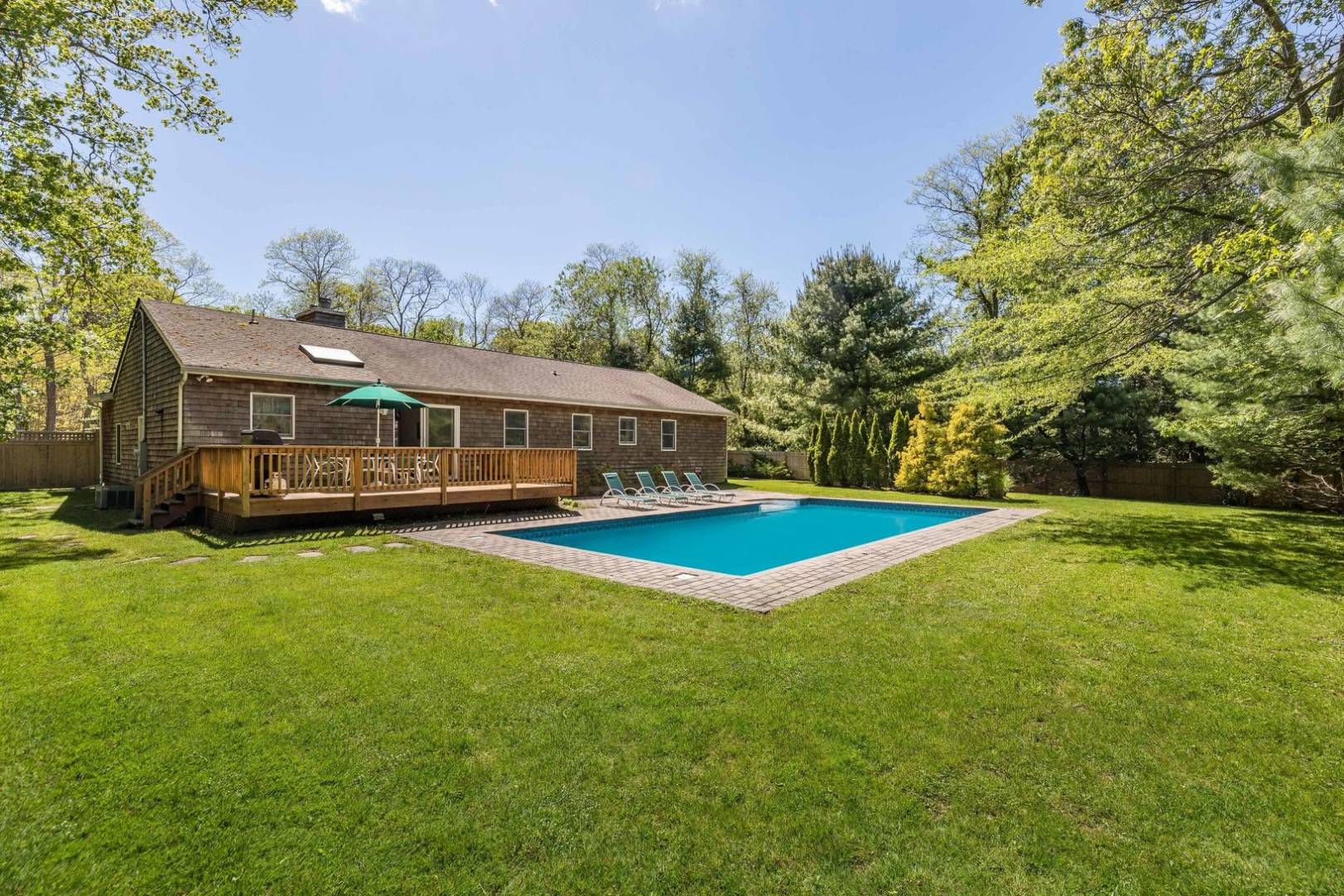 41 Sandra Road East Hampton, NY 11937 - Photo 3 of 16 a view of swimming pool with lawn chairs and plants