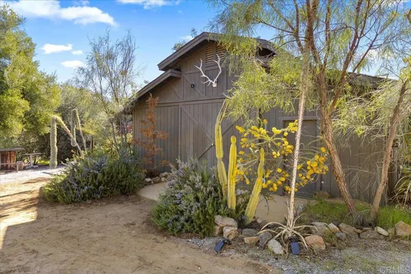 a view of a house with a tree in the background