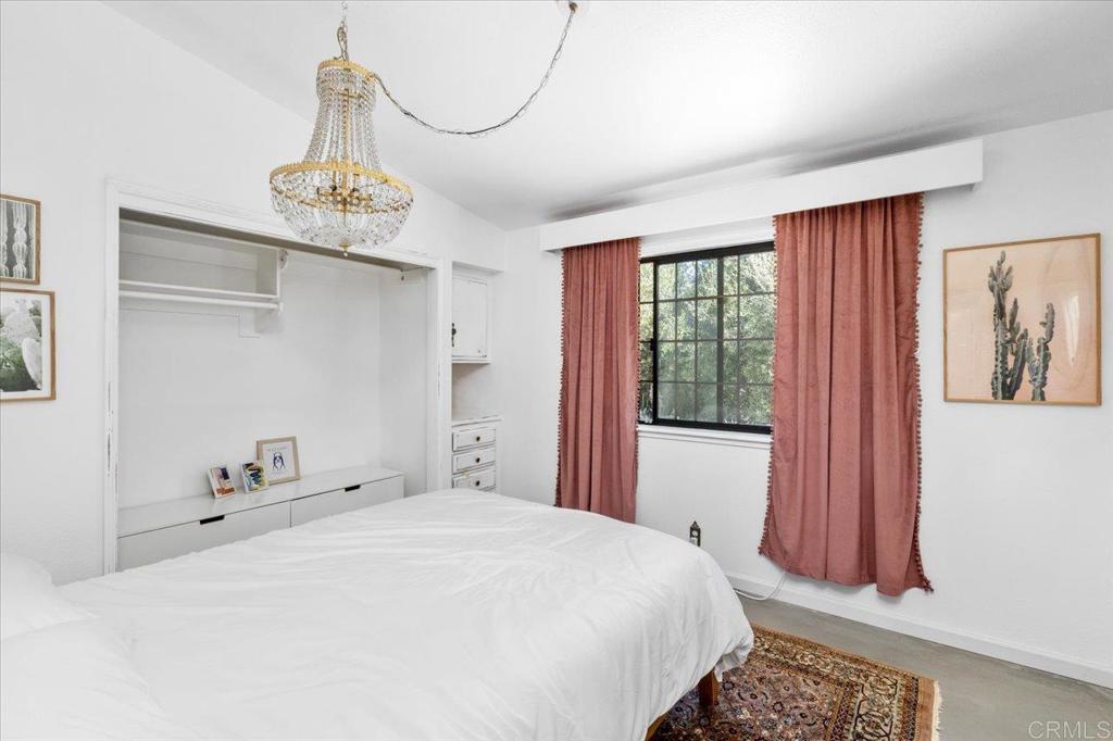 40707 Intrepid Road Hemet, CA 92544 - Photo 13 of 71 a bedroom with a bed and a chandelier