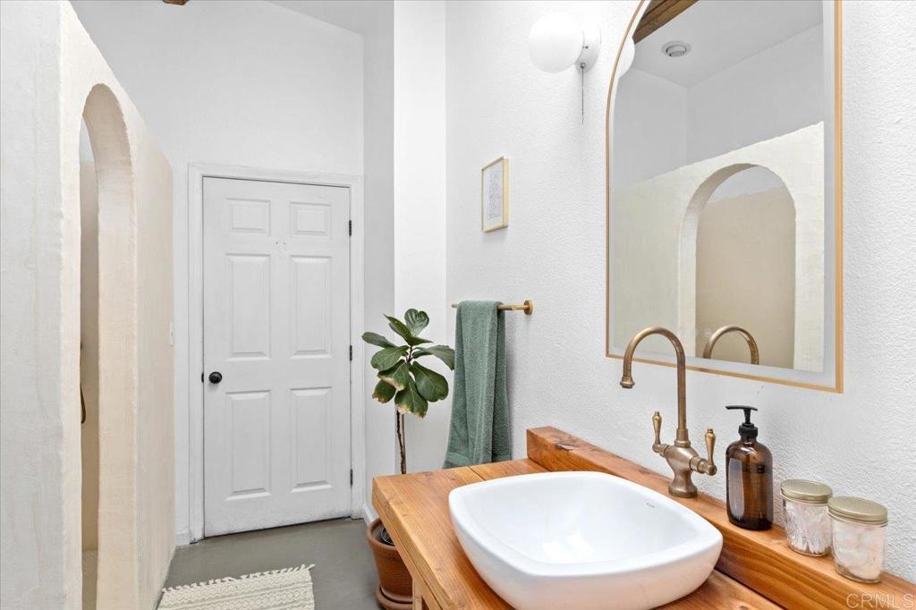 40707 Intrepid Road Hemet, CA 92544 - Photo 16 of 71 a bathroom with a granite countertop sink a toilet and a mirror