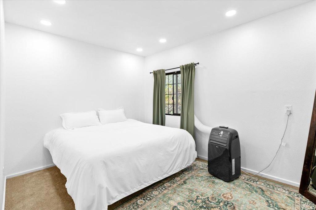 40707 Intrepid Road Hemet, CA 92544 - Photo 21 of 71 a bedroom with a bed and a mirror