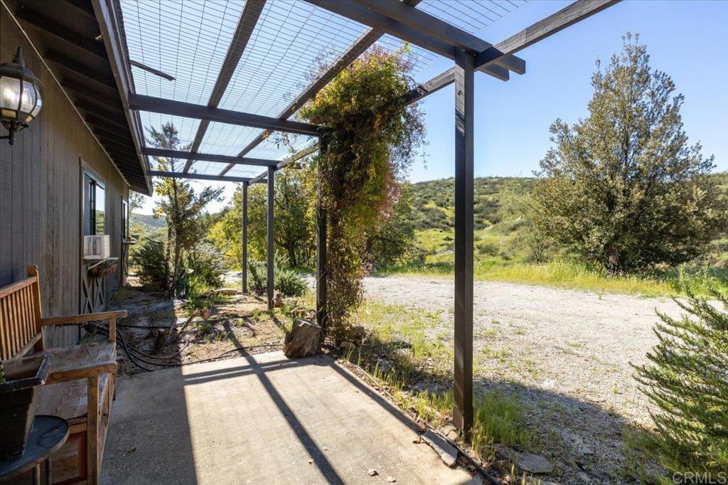 40707 Intrepid Road Hemet, CA 92544 - Photo 26 of 71 a view of a porch with chairs and backyard of the house