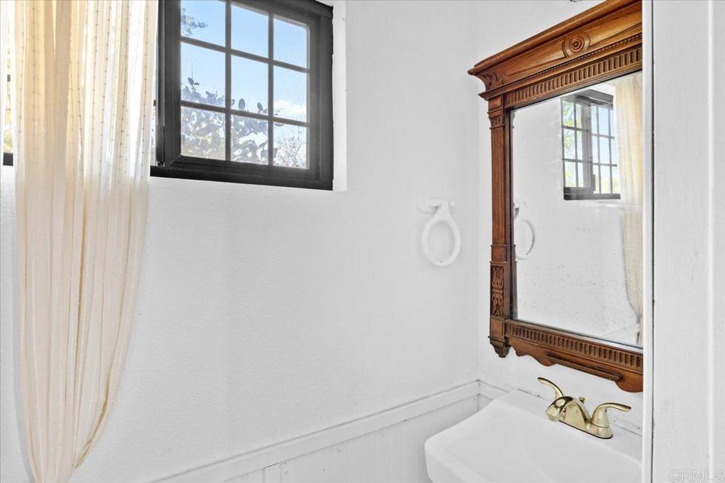40707 Intrepid Road Hemet, CA 92544 - Photo 31 of 71 a bathroom with a sink and a mirror