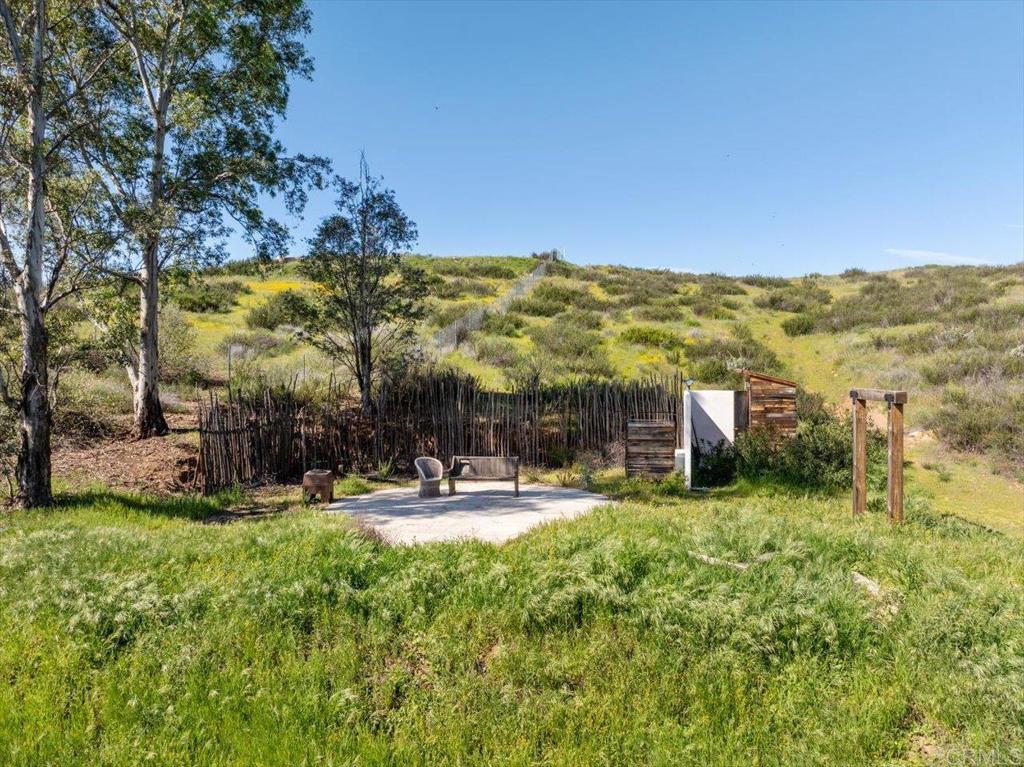 40707 Intrepid Road Hemet, CA 92544 - Photo 59 of 71 a view of a swimming pool with lawn chairs and a big yard