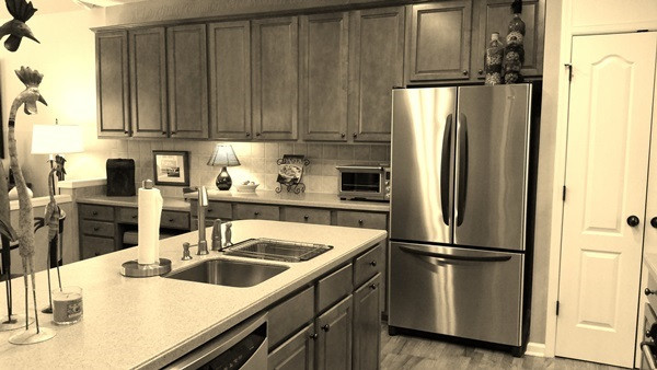 Custom Cabinets 42" with Tile Backsplash, Corian Countertops, Eat-in-Kitchen, Hardwood floors, Double Door Pantry, upgraded oil rubbed bronze egg door knobs, and plenty of cabinets! Kitchen