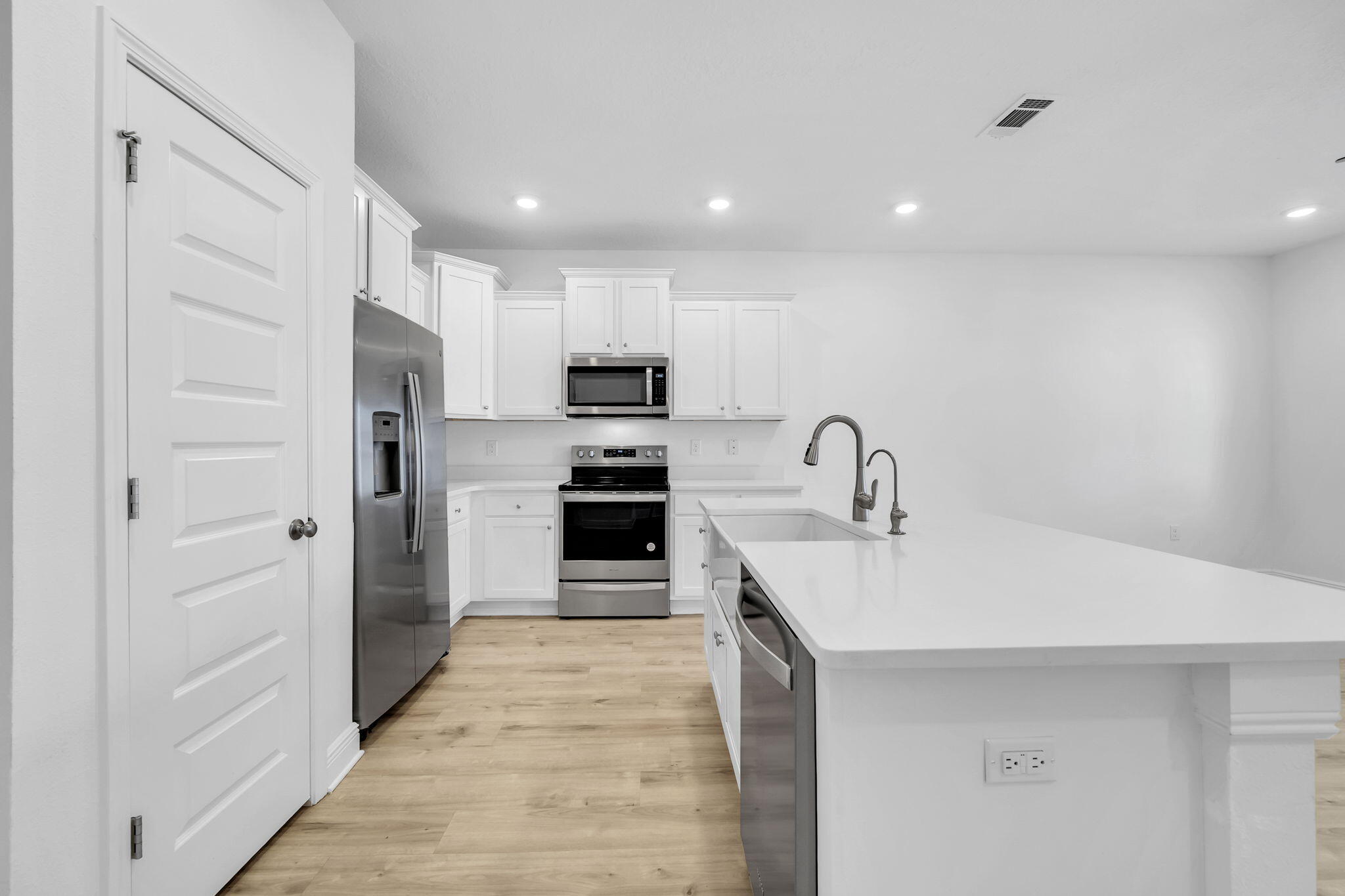 22 Redbird Loop Destin, FL 32541 - Photo 11 of 40 a kitchen with kitchen island a sink appliances and cabinets