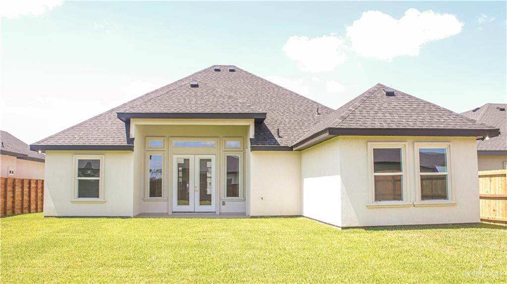 900 Azalea Street Mission, TX 78573 - Photo 6 of 12 Rear exterior featuring stucco siding, multiple windows, and a covered patio with double glass doors