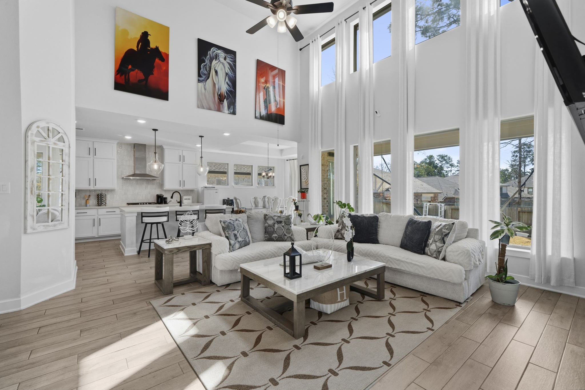 511 Carina Gaze Drive Conroe, TX 77318 - Photo 10 of 45 This spacious living area features a high ceiling with large windows that allow plenty of natural light.