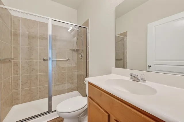 a bathroom with a sink toilet and shower