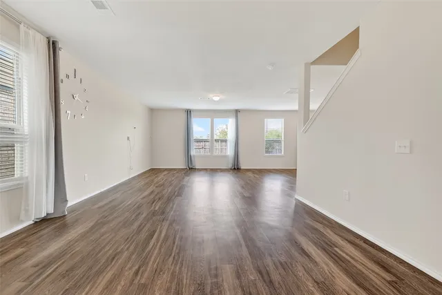 a view of wooden floor and windows in a room