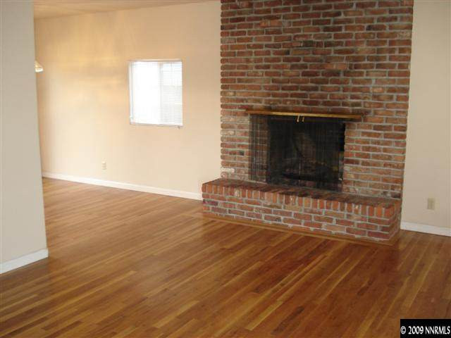 1540 University Terrace Reno, NV 89503 - Photo 7 of 9 a view of empty room with wooden floor and fireplace