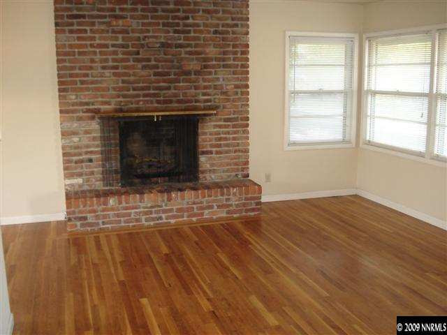 1540 University Terrace Reno, NV 89503 - Photo 8 of 9 a view of empty room with wooden floor and fireplace