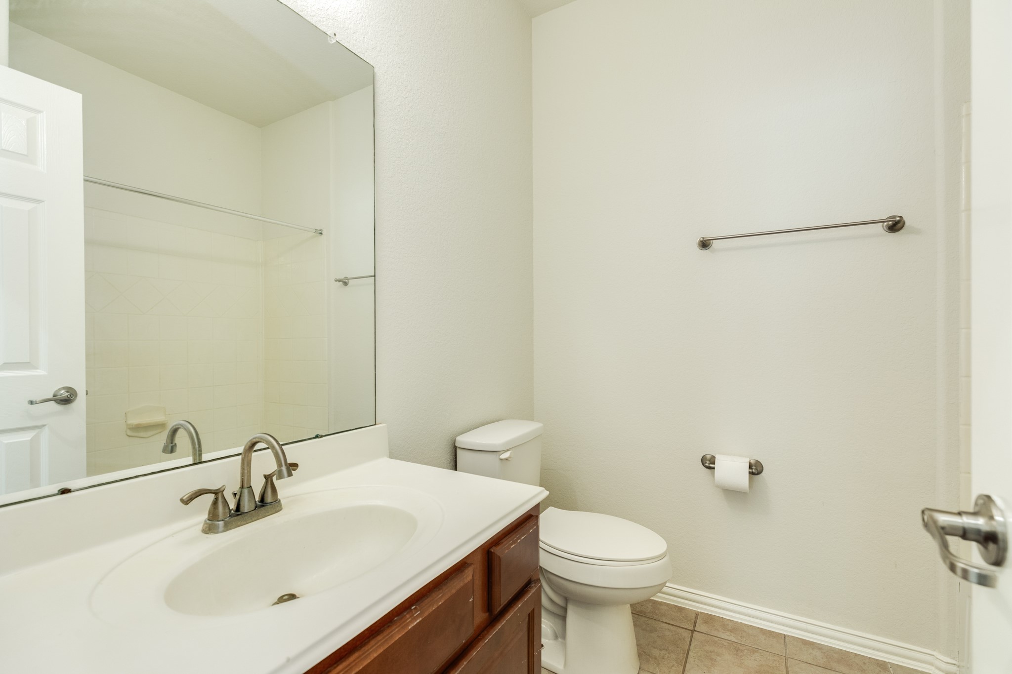 13417 Star Creek Lane Rosharon, TX 77583 - Photo 25 of 41 Secondary bathroom with quartz countertop, large mirror, and a tub/shower combo.