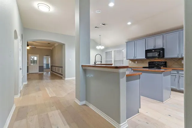 a kitchen with stainless steel appliances granite countertop a refrigerator and a stove