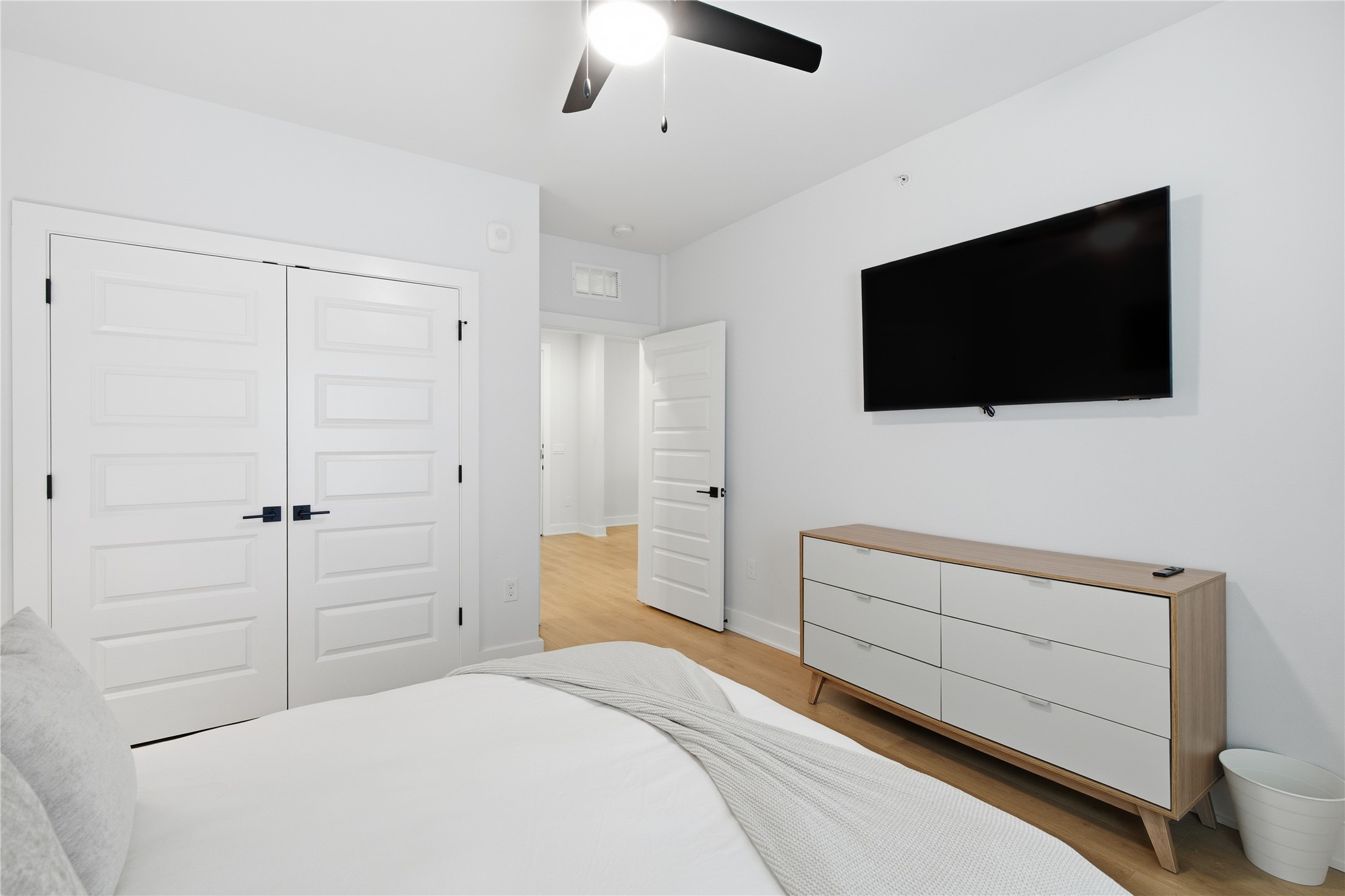 2500 Longview Street, Unit 219 Austin, TX 78705 - Photo 10 of 40 Bedroom with a closet, a ceiling fan, and light wood finished floors