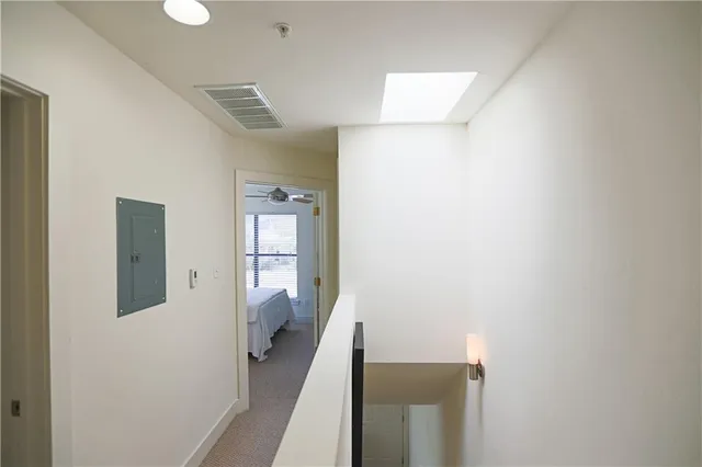a view of a hallway with wooden floor and entryway