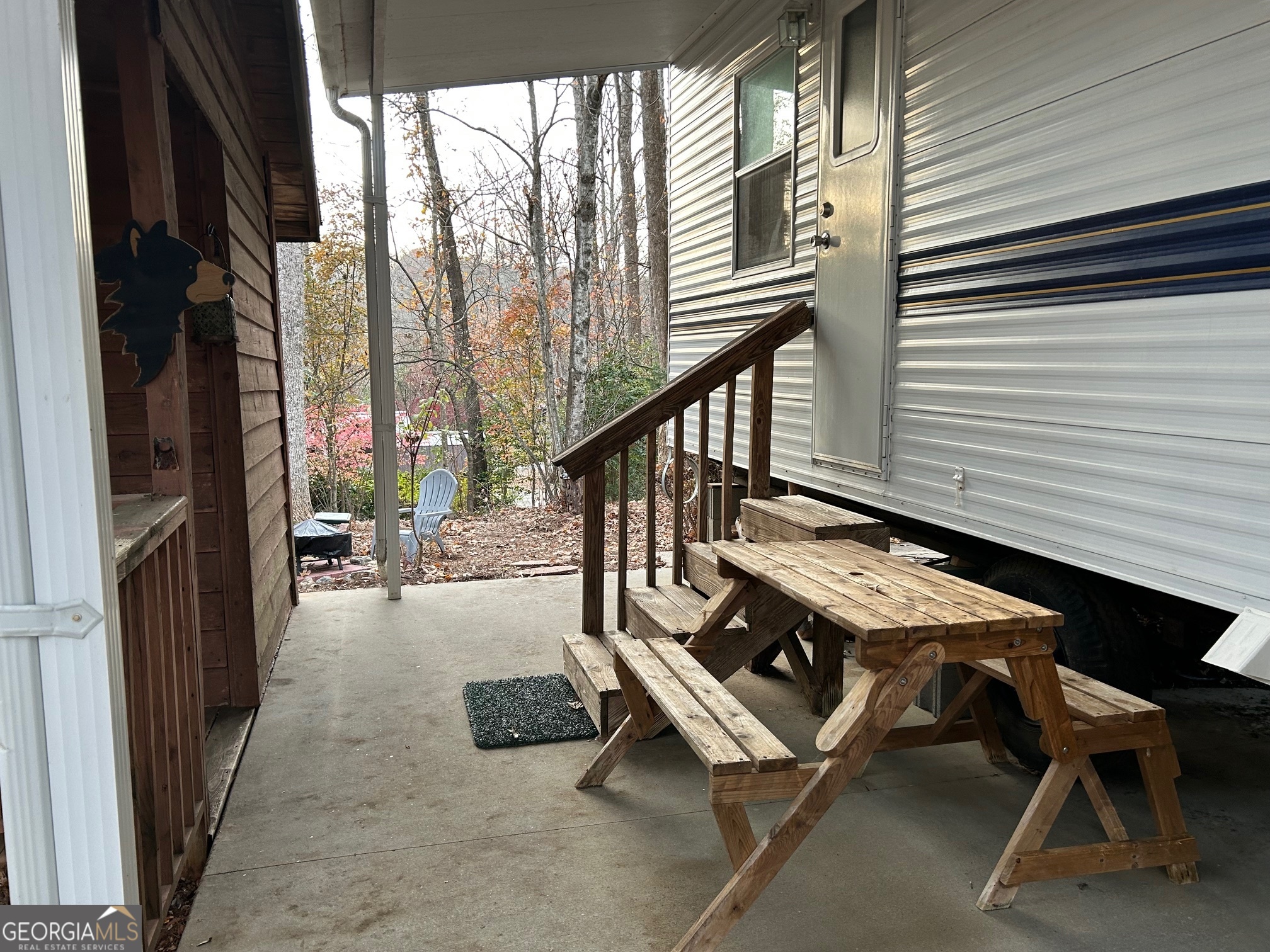 79 Maple Wood Lane Cleveland, GA 30528 - Photo 16 of 18 a backyard of a house with table and chairs
