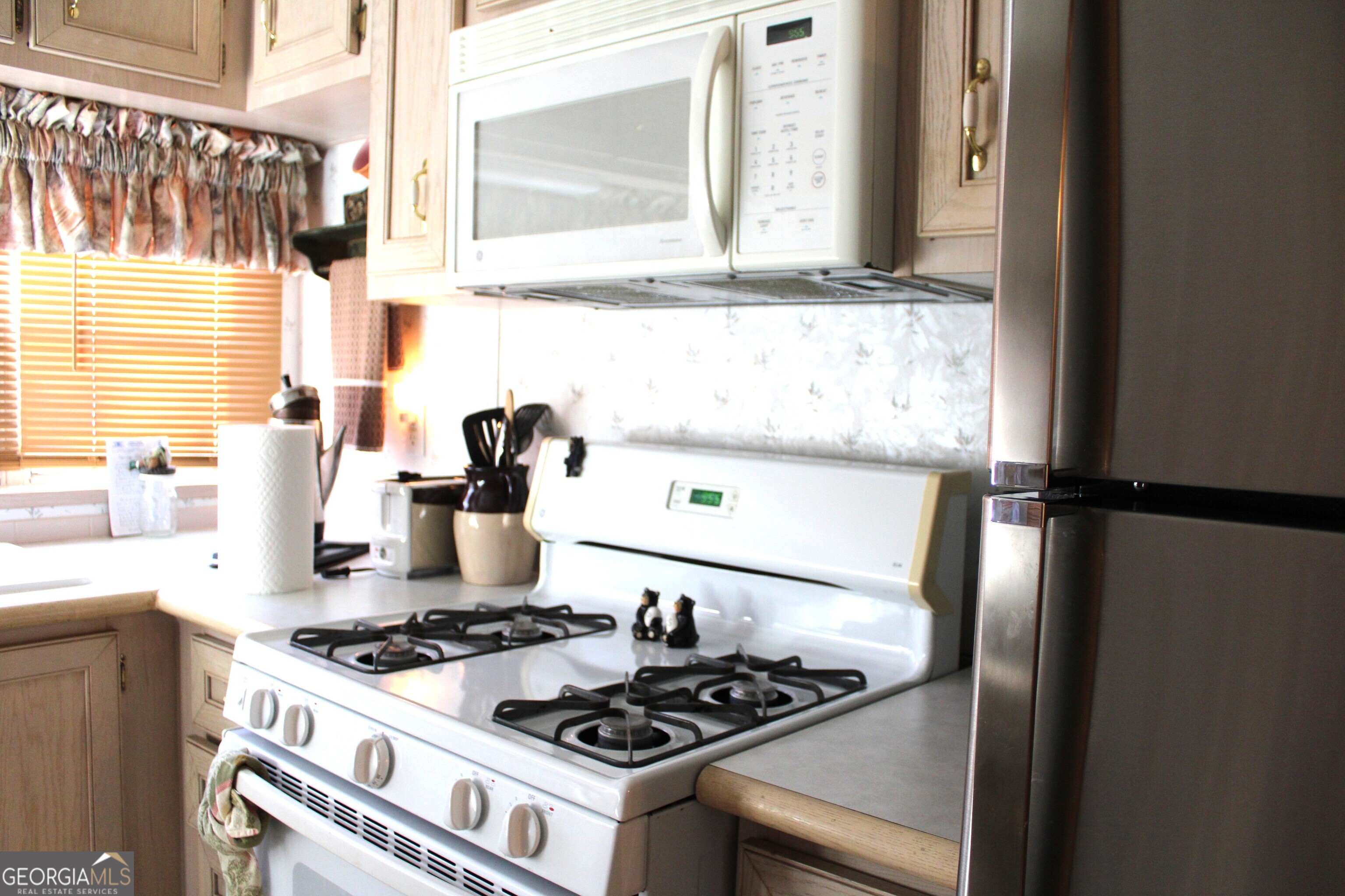 79 Maple Wood Lane Cleveland, GA 30528 - Photo 8 of 18 a kitchen with a stove and a window