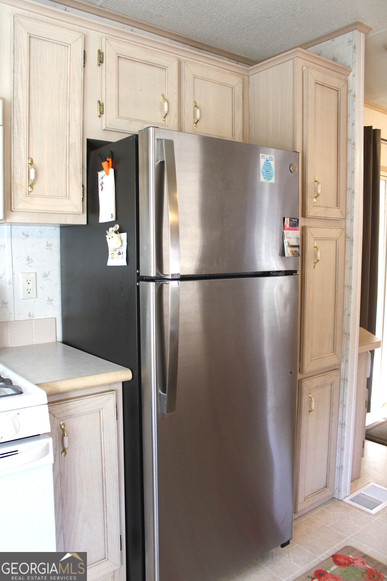 79 Maple Wood Lane Cleveland, GA 30528 - Photo 9 of 18 a white refrigerator freezer and a stove sitting inside of a kitchen
