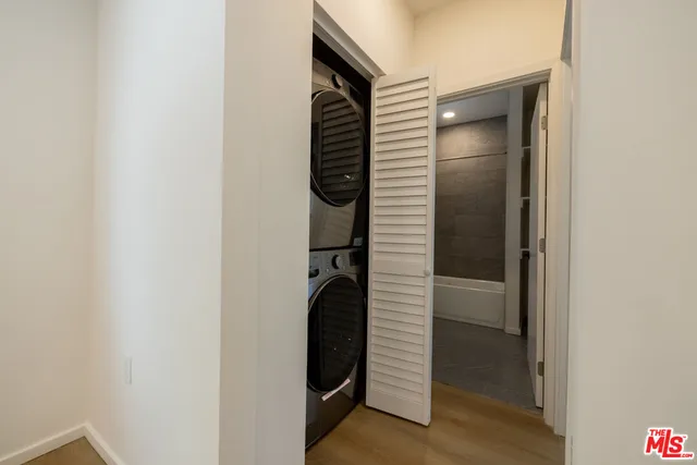 a view of a backyard with wooden fence and large trees