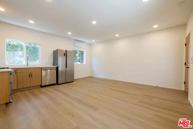 a view of a kitchen with a sink and stainless steel appliances