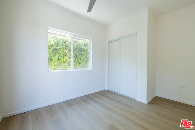 a view of room with window and hardwood floor