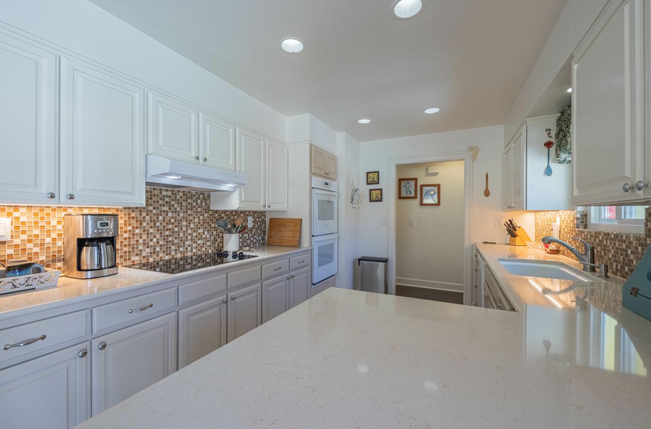 18101 Berta Canyon Road Salinas, CA 93907 - Photo 13 of 32 a kitchen with granite countertop a sink stove and cabinets