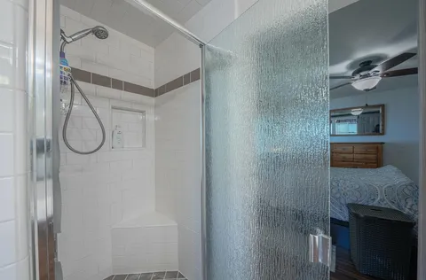 a bathroom with a shower and a mirror