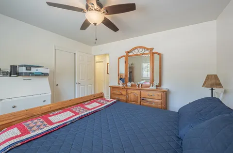 a living room with a bed furniture and a window