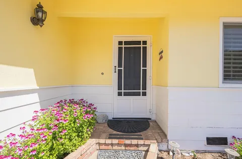 a front view of a house with flowers